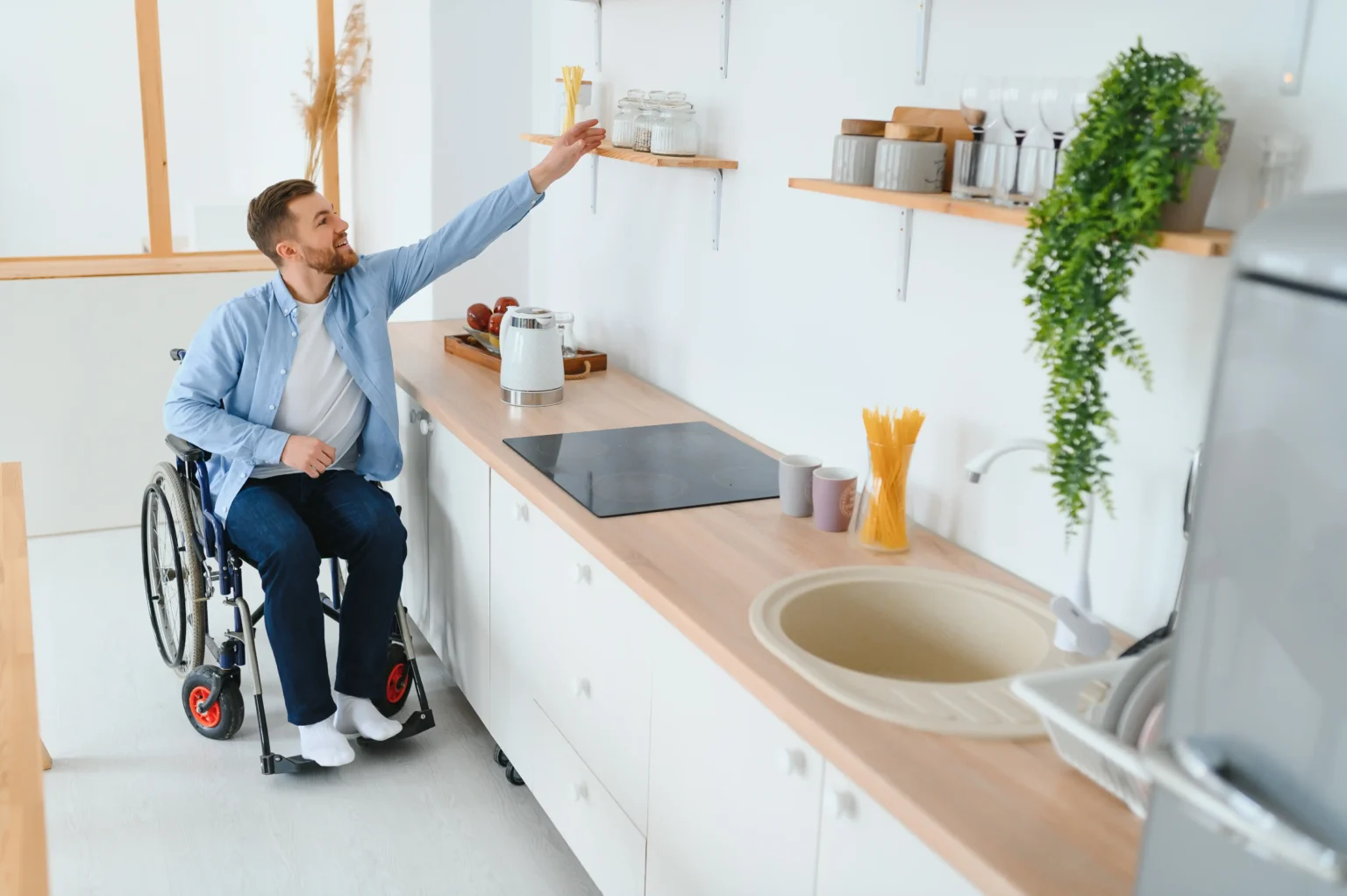 disabled-young-man-in-wheelchair-preparing-food-in-2025-03-16-16-34-11-utc